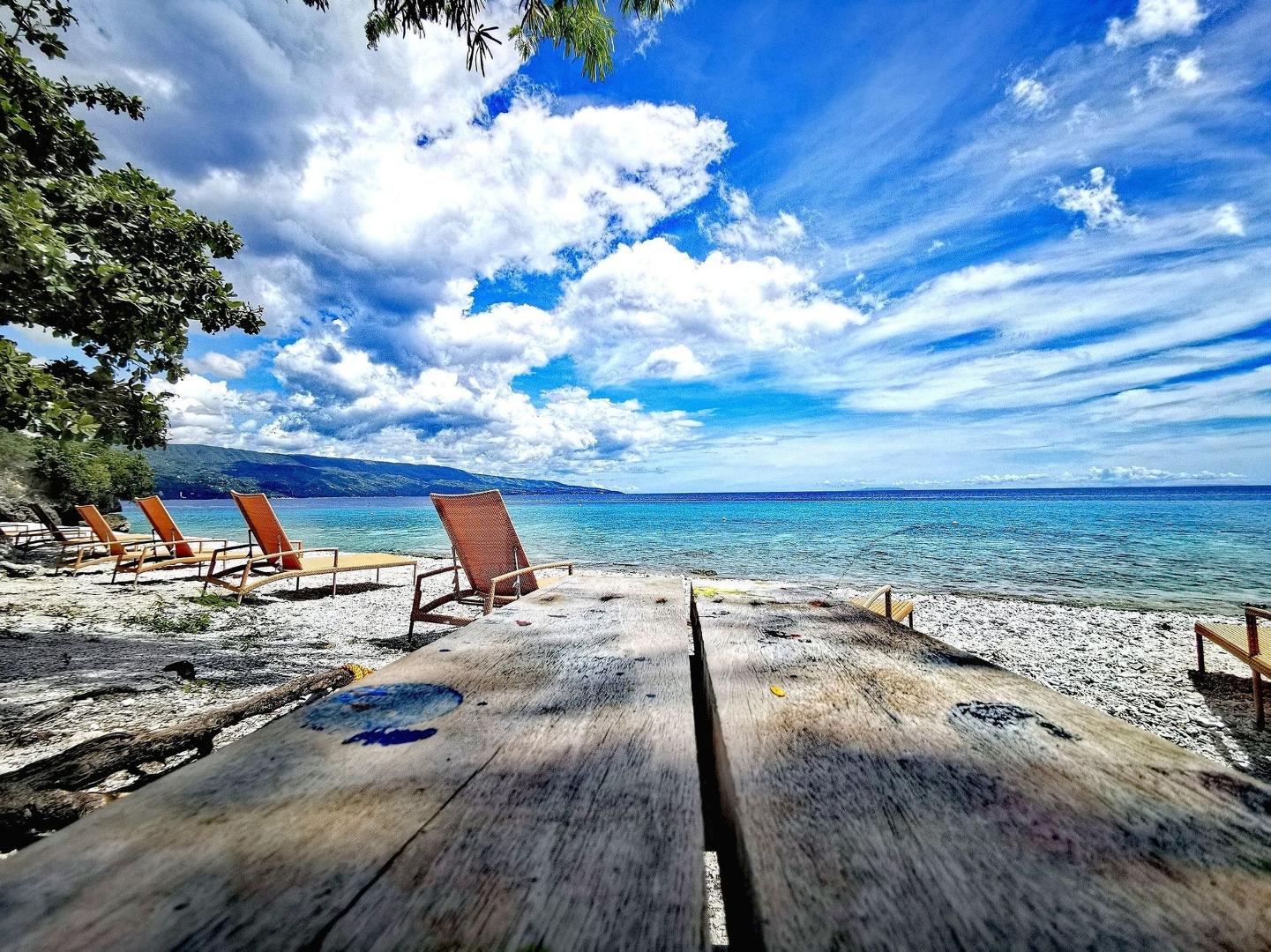 Wooden seaside deck overlooking the clear turquoise waters of Sumilon Island