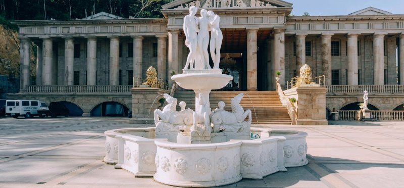 Grand white marble fountain with classical statues in front of Temple of Leah.
