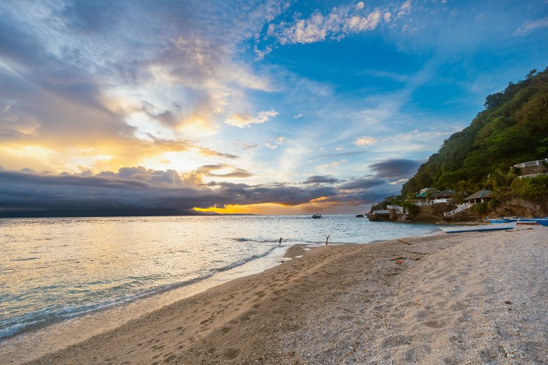 Sunrise over a beautiful white sand beach in Alcoy, Cebu.